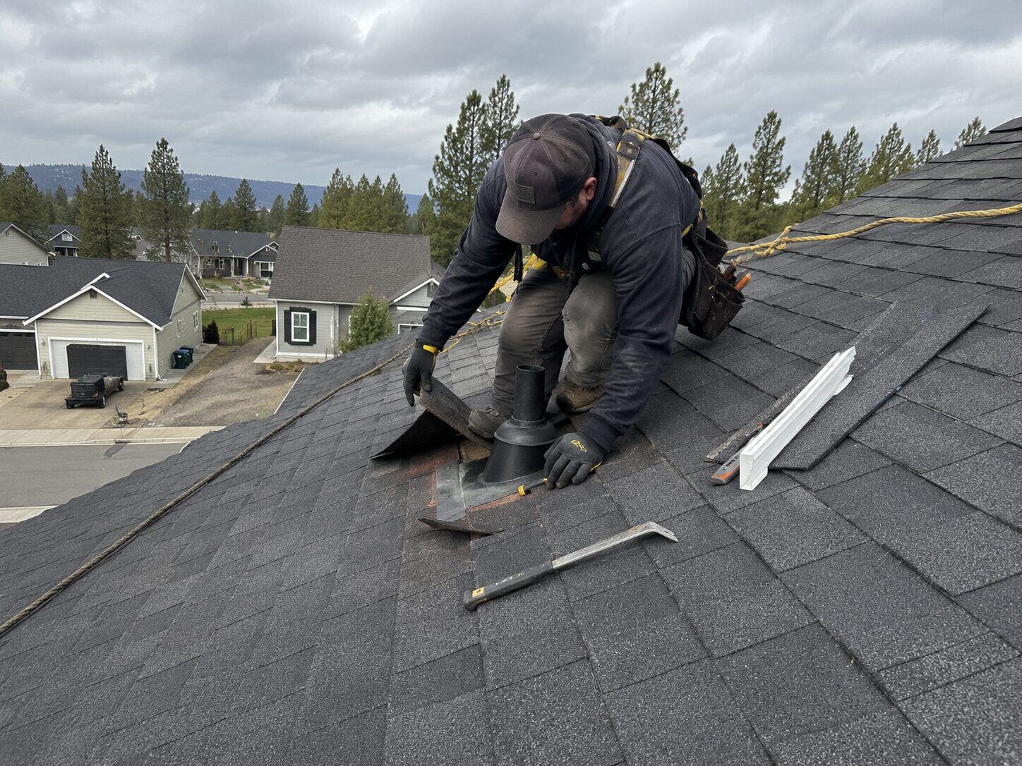 Roofer repairing a roof vent boot that was the source of an attic leak