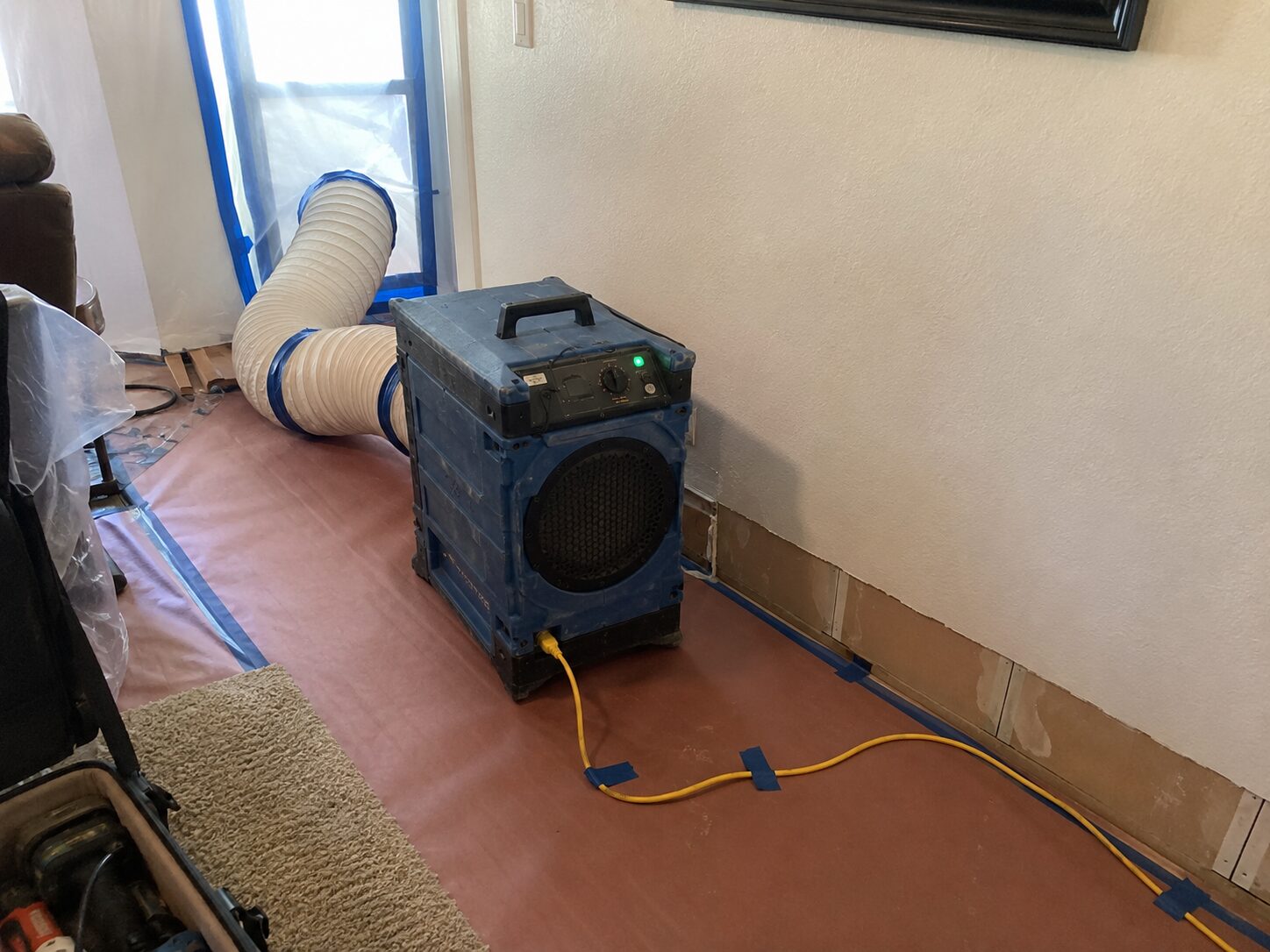 HEPA air scrubber running in a room during remediation